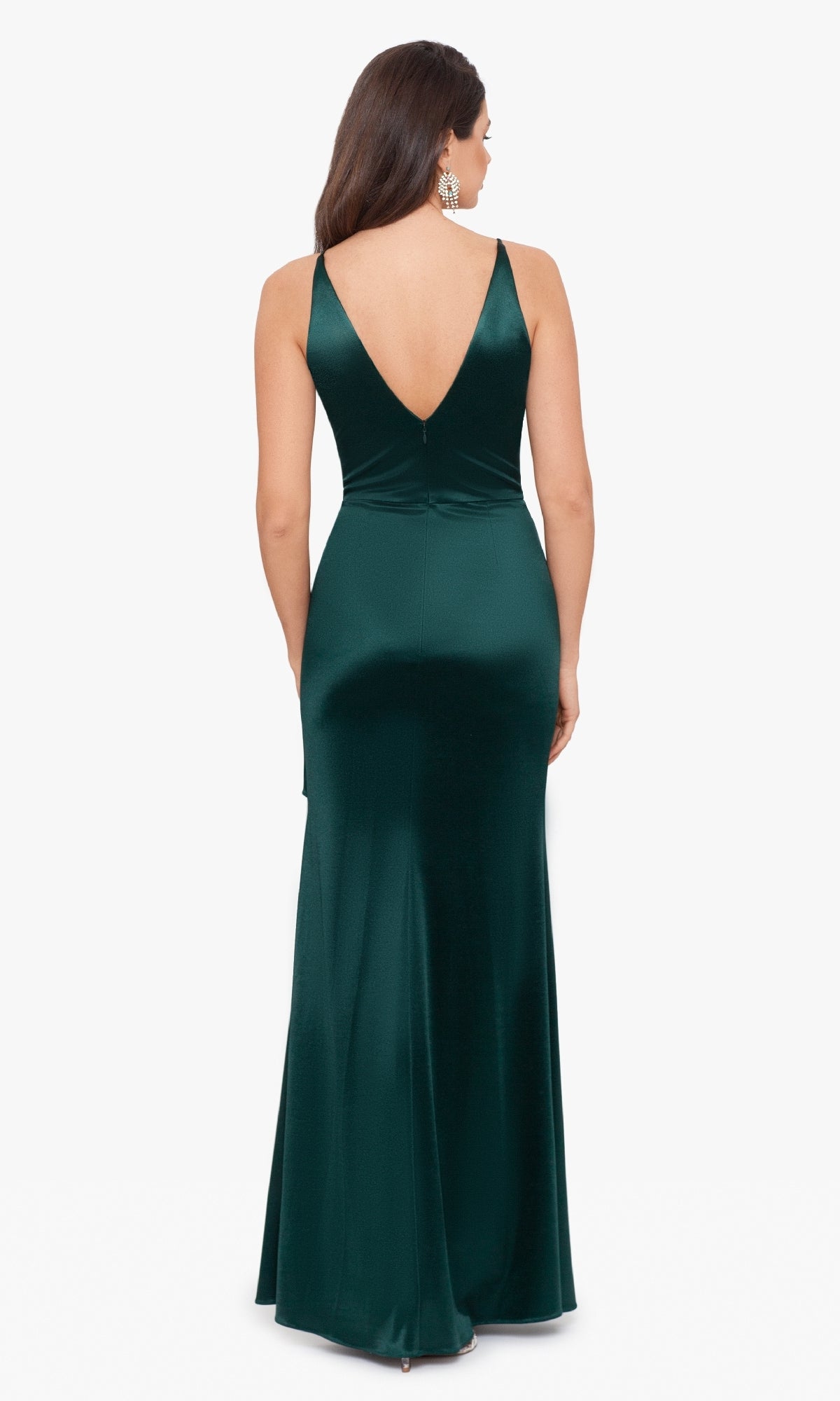 A woman in the Blondie Nites Side Drape Long Formal Dress 3458BN, a sleeveless floor-length dark green satin gown with a deep V-back, stands facing away against a white background.